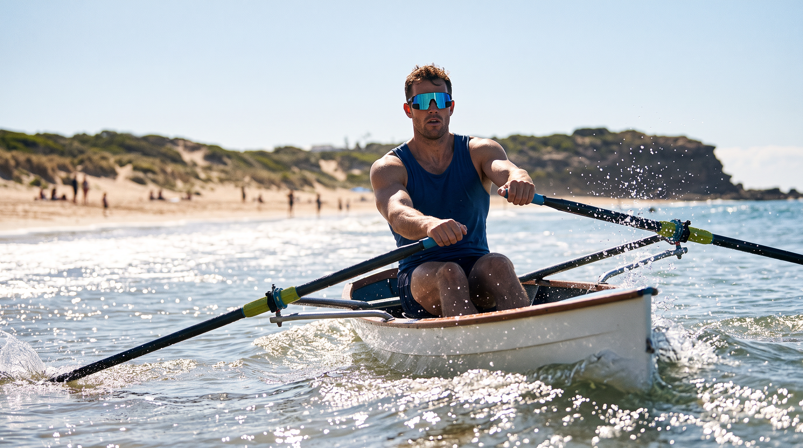 Coastal rower in a single scull turning through surf near the beach, wearing sport wraparound sunglasses with a rear-view mirror in the lens